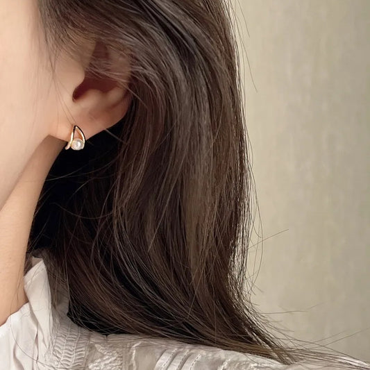 Model wearing Teardrop Pearl Stud Earrings with minimalist outfit, showcasing elegant pearl drop design