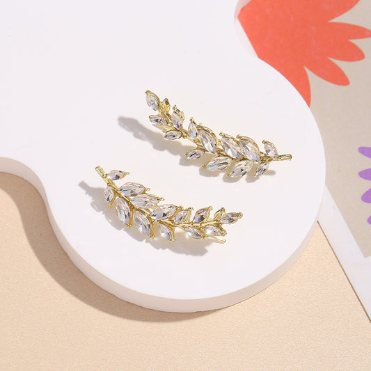 Close-up of wheat ear design earrings with intricate detailing