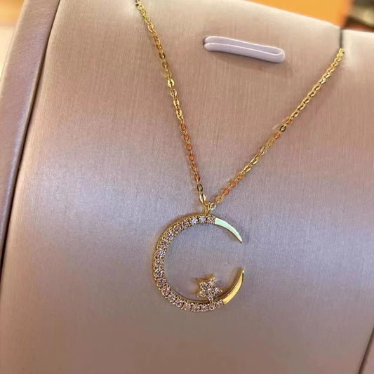 Close-up photo of Star and Moon Necklace showing star and moon pendant details