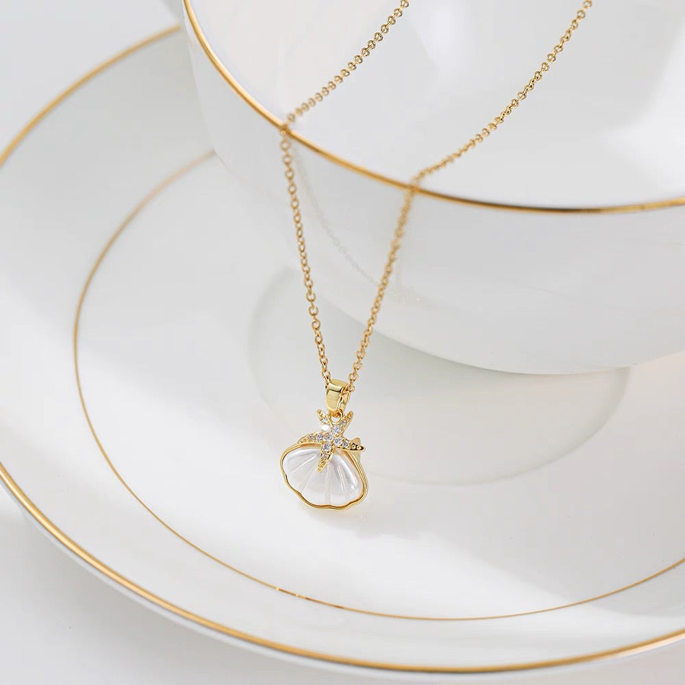 Whispers of the Tide: Dive into the Enchanting World of Our Starfish & Seashell Pendant Necklace